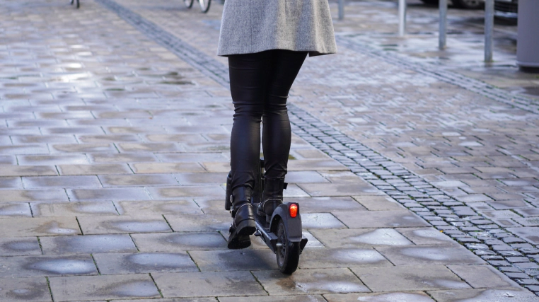 e scooter being used by woman in the city 1